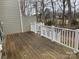 A wooden deck with a white railing provides an outdoor seating area at 16721 Spinnaker Ln, Cornelius, NC 28031