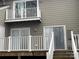 A home's rear exterior with a two-level deck and railings at 16721 Spinnaker Ln, Cornelius, NC 28031