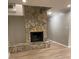 Stunning stone fireplace stands as a focal point in the living room with new floors at 16721 Spinnaker Ln, Cornelius, NC 28031