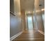 Bright hallway with hardwood floors leads to rooms in this inviting home at 16721 Spinnaker Ln, Cornelius, NC 28031
