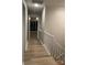 Second floor hallway featuring hardwood floors and natural light at 16721 Spinnaker Ln, Cornelius, NC 28031