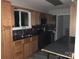 Well-lit kitchen features stainless steel appliances, ample cabinet space and dark countertop at 16721 Spinnaker Ln, Cornelius, NC 28031