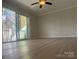 Spacious living room featuring hardwood floors and sliding glass doors with natural light at 16721 Spinnaker Ln, Cornelius, NC 28031