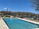 Community pool with lounge chairs and waterfront views for relaxing summer days at 16721 Spinnaker Ln, Cornelius, NC 28031