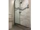 Updated shower featuring stone floor, neutral tile and a built in niche at 16721 Spinnaker Ln, Cornelius, NC 28031