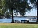 Picturesque waterfront view with benches, mature trees, and boats docked nearby at 16721 Spinnaker Ln, Cornelius, NC 28031