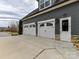 Attached two-car garage featuring paneled doors and adjacent entrance to the side of the home at 16733 Reinsch Dr, Davidson, NC 28036