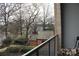 Relaxing balcony view overlooking quiet residential street with mature trees and charming homes, perfect for enjoying the outdoors at 2116 Mcclintock Rd, Charlotte, NC 28205
