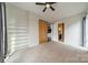Bright bedroom features a ceiling fan, a sliding barn door and custom built-in shelving at 2116 Mcclintock Rd, Charlotte, NC 28205