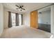 Bedroom featuring neutral carpet, natural light, ceiling fan and adjacent room with sliding door at 2116 Mcclintock Rd, Charlotte, NC 28205