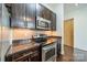Modern kitchen boasts stainless appliances, dark cabinets, and granite counters, ideal for cooking at 2116 Mcclintock Rd, Charlotte, NC 28205