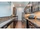 Well-equipped kitchen features stainless appliances, granite counters, and sleek dark wood cabinets at 2116 Mcclintock Rd, Charlotte, NC 28205