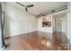 Inviting living room featuring hardwood floors, exposed ductwork, ceiling fan and open view to kitchen at 2116 Mcclintock Rd, Charlotte, NC 28205
