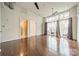 Open living space featuring hardwood floors and large windows with a balcony at 2116 Mcclintock Rd, Charlotte, NC 28205