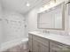 Elegant bathroom with marble shower, modern vanity, and gray cabinets at 2312 Roland Dr, Monroe, NC 28110