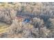 An aerial view of the home nestled into a private wooded lot with long driveway at 252 Big Lick Rd, Stanfield, NC 28163