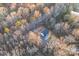Aerial view of white home with dark roof surrounded by mature trees and long driveway at 252 Big Lick Rd, Stanfield, NC 28163