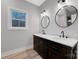 Bathroom featuring a double sink vanity with marble countertops and brushed nickel hardware at 252 Big Lick Rd, Stanfield, NC 28163