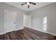 Neutral bedroom features wood-look floors, a ceiling fan and two white paneled doors at 252 Big Lick Rd, Stanfield, NC 28163