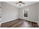 This bedroom features new hardwood floors, a ceiling fan and a window to the exterior at 252 Big Lick Rd, Stanfield, NC 28163