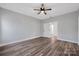 Spacious bedroom with ceiling fan, wood-look floors, white trim and two white paneled doors at 252 Big Lick Rd, Stanfield, NC 28163