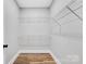 Walk-in closet with white shelving, wood-look flooring and base trim at 252 Big Lick Rd, Stanfield, NC 28163
