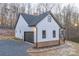 View of home's side exterior, white siding, stone accents and attached garage at 252 Big Lick Rd, Stanfield, NC 28163