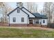 Side exterior view shows the home's well-manicured lawn and brick-lined foundation at 252 Big Lick Rd, Stanfield, NC 28163