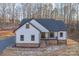 Exterior of home with white siding, dark roof, covered porch and landscaped yard at 252 Big Lick Rd, Stanfield, NC 28163