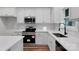 Modern kitchen featuring stainless steel appliances, white cabinets, and quartz countertops at 252 Big Lick Rd, Stanfield, NC 28163