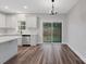 Open concept kitchen featuring white cabinets, stainless steel appliances and vinyl flooring at 252 Big Lick Rd, Stanfield, NC 28163