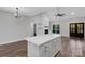 Bright open-concept living area and kitchen with hardwood floors and a large island at 252 Big Lick Rd, Stanfield, NC 28163