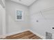 Laundry room with closet system, window and vinyl flooring at 252 Big Lick Rd, Stanfield, NC 28163