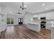 Open living room featuring an island, kitchen, dining area and vinyl flooring at 252 Big Lick Rd, Stanfield, NC 28163