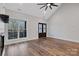 Living room with hardwood floors and double doors to a balcony overlooking the wooded lot at 252 Big Lick Rd, Stanfield, NC 28163