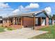 Brick ranch home with blue accents and covered porch at 2525 Oxford Cir, Lancaster, SC 29720