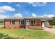 Brick ranch home with a covered porch, new landscaping, and a carport at 2525 Oxford Cir, Lancaster, SC 29720