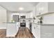 Modern kitchen with white cabinets, granite island, and stainless steel appliances at 2525 Oxford Cir, Lancaster, SC 29720