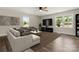 Spacious living room with hardwood floors, large windows, and a ceiling fan at 2525 Oxford Cir, Lancaster, SC 29720