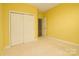 Bedroom with double-door closet and carpet at 2534 Old Ashworth Nw Ln, Concord, NC 28027