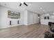 Bright living room featuring hardwood floors and a large TV at 4211 Center Place Dr, Harrisburg, NC 28075