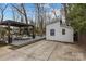 An outdoor area with a deck, pergola, workout shed and concrete pad at 4238 Wright Ave, Charlotte, NC 28211