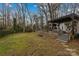 Sprawling backyard featuring deck, pergola, steps, and lush green lawn at 4238 Wright Ave, Charlotte, NC 28211