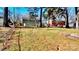 Large backyard with mature trees and chain link fence at 4513 Munsee St, Charlotte, NC 28213