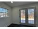 Bright basement room with French doors leading to backyard at 4513 Munsee St, Charlotte, NC 28213