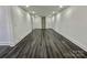 Long basement hallway with gray vinyl plank flooring at 4513 Munsee St, Charlotte, NC 28213
