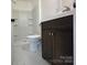 Bathroom with dark vanity and marble-look flooring at 4513 Munsee St, Charlotte, NC 28213