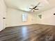 Spacious bedroom with ceiling fan and grey wood-look flooring at 4513 Munsee St, Charlotte, NC 28213