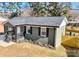 Cozy home with fresh landscaping, dark shutters, and a modern painted exterior at 4513 Munsee St, Charlotte, NC 28213