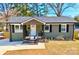 Inviting single-story home featuring fresh paint, a covered porch, and tidy landscaping at 4513 Munsee St, Charlotte, NC 28213